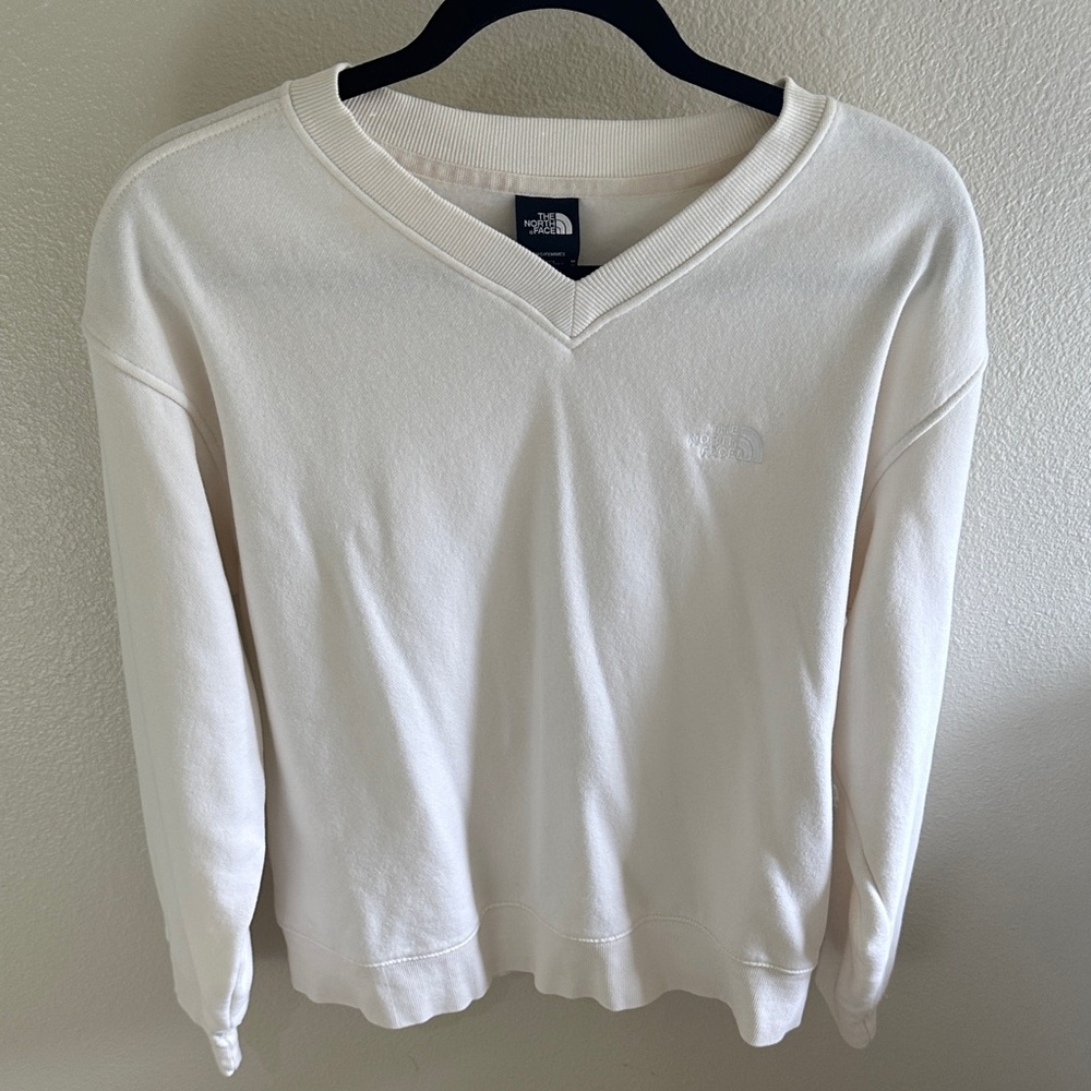 The North Face women’s  Off-White V-Neck Sweat shirt.